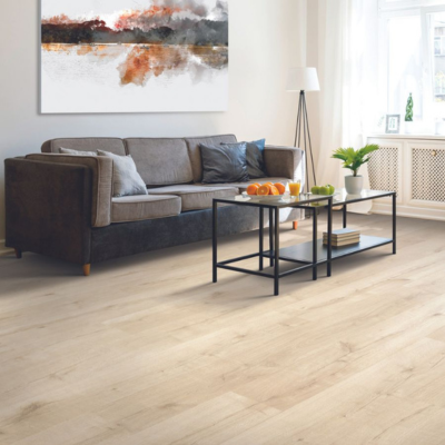 Bright living room with light wood laminate flooring, a gray sofa, abstract wall art, and black metal-framed coffee tables, illuminated by natural light from a large window.